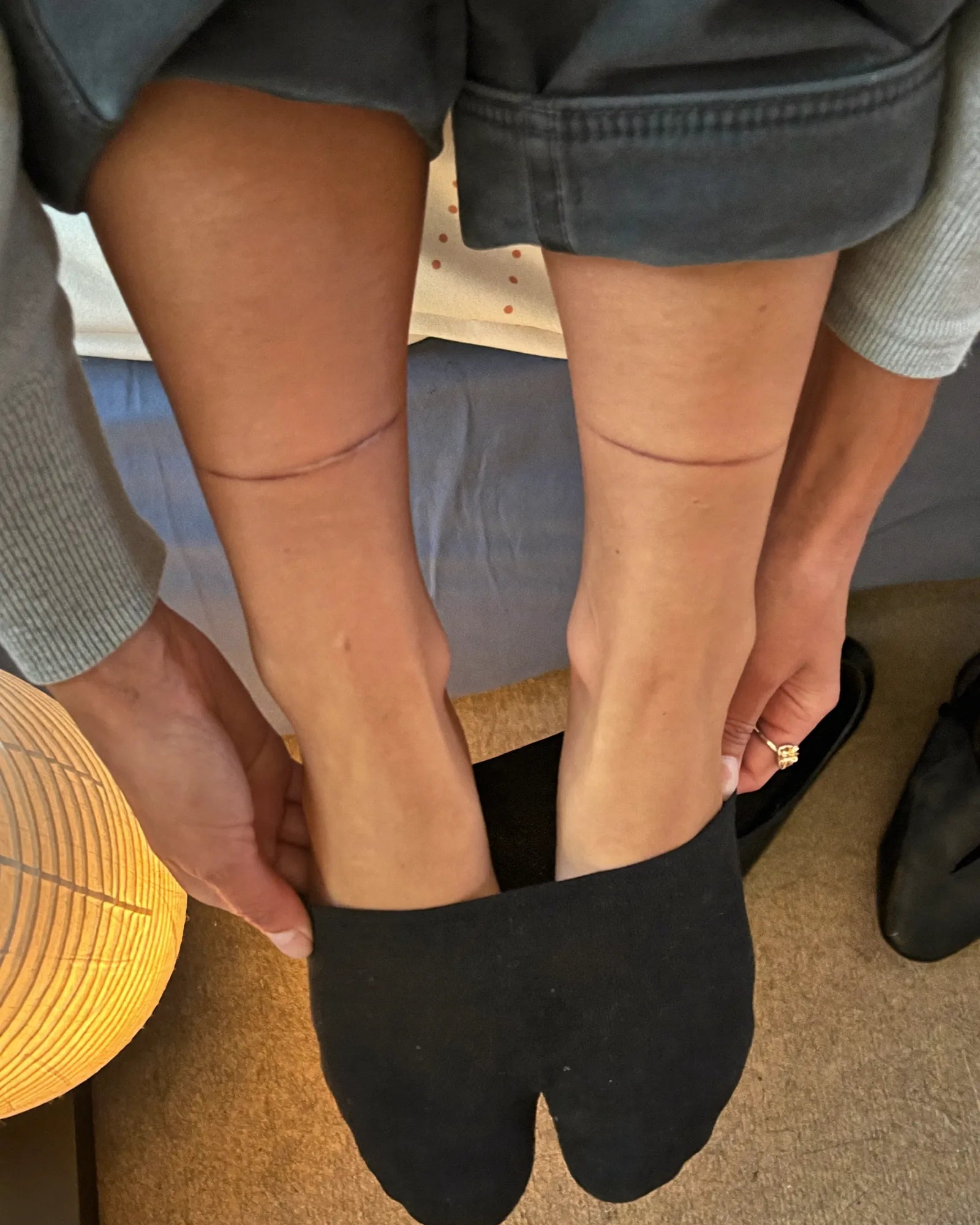 Woman rolling her socks down at the end of the day