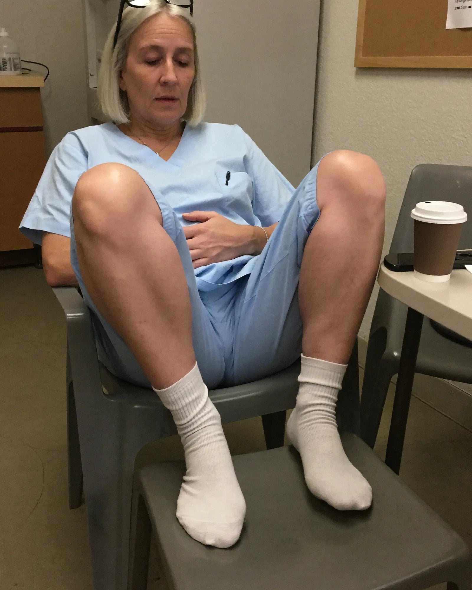 Nurse with her feet up on a second chair in the break room